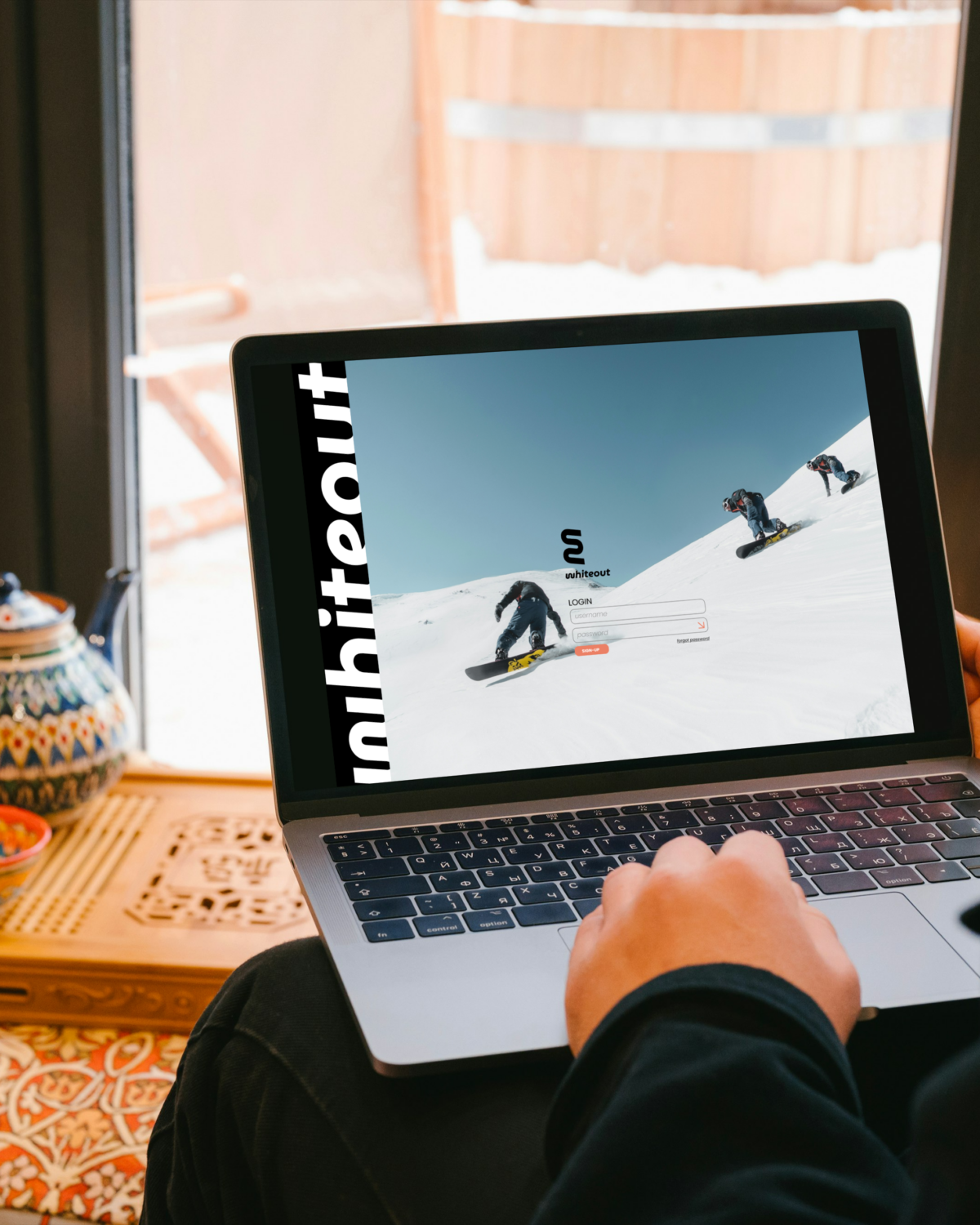 Whiteout log-in page on a computer in a cozy cabin.